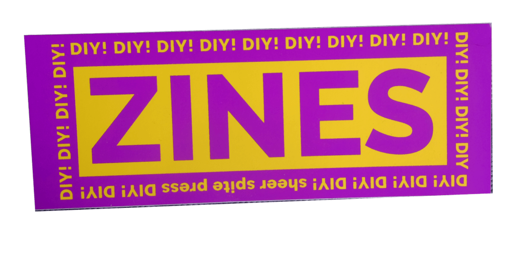 A sticker that reads "ZINES" in big letters, with a border reading "DIY!" over and over